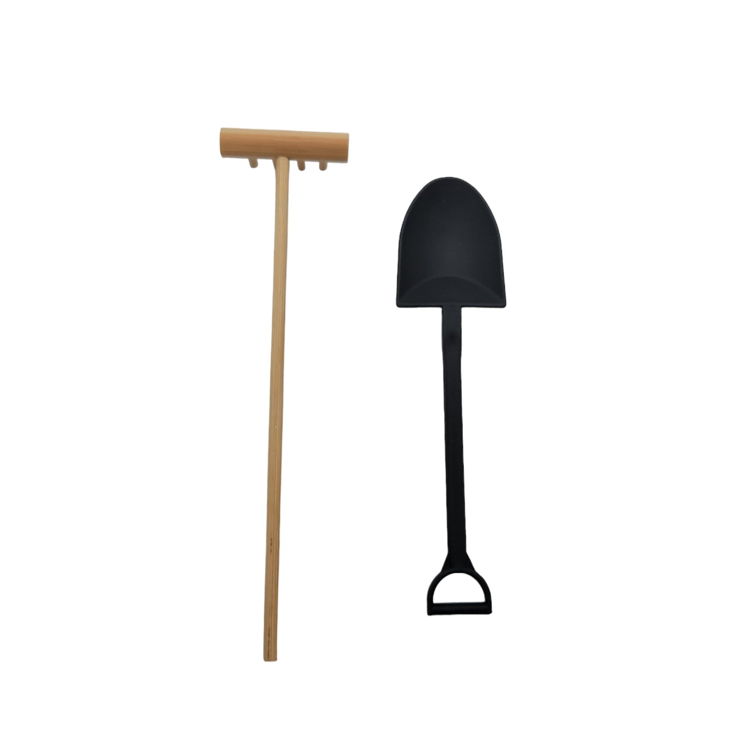 Black garden shovel and wooden rake on a white background