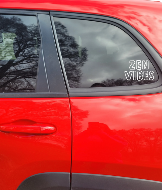 Red car with 'Zen Vibes' decal on window