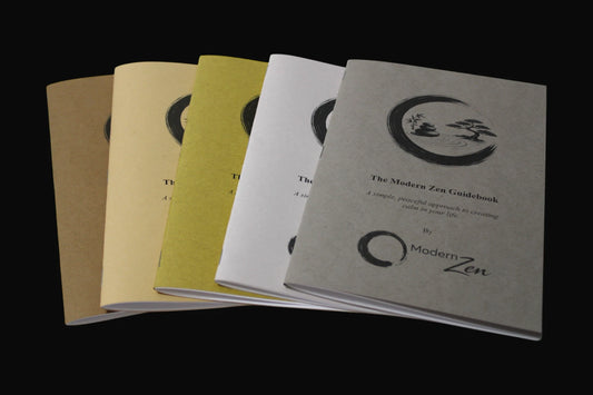 Books titled 'The Modern Zen Guidebook' by Modern Zen in 5 different colors on a black background