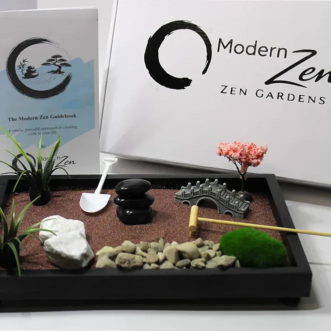 Zen garden with rocks, plants, and a bridge on a tray, branded 'Modern Zen'.