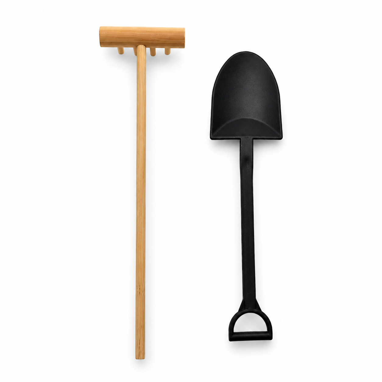 a wooden rake and plastic shovel on a white background