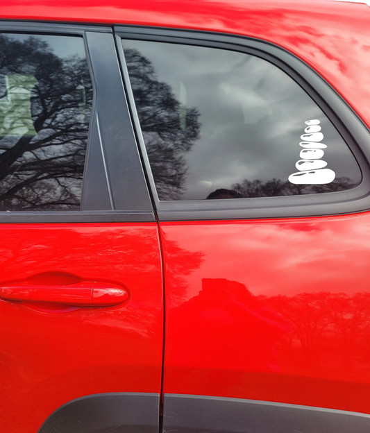 Close-up of a red car door with a stacked rocks window decal.
