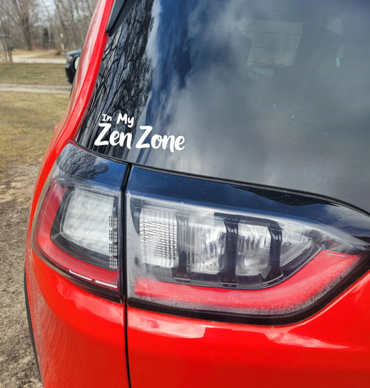 Red car with 'In My Zen Zone' decal on the back window